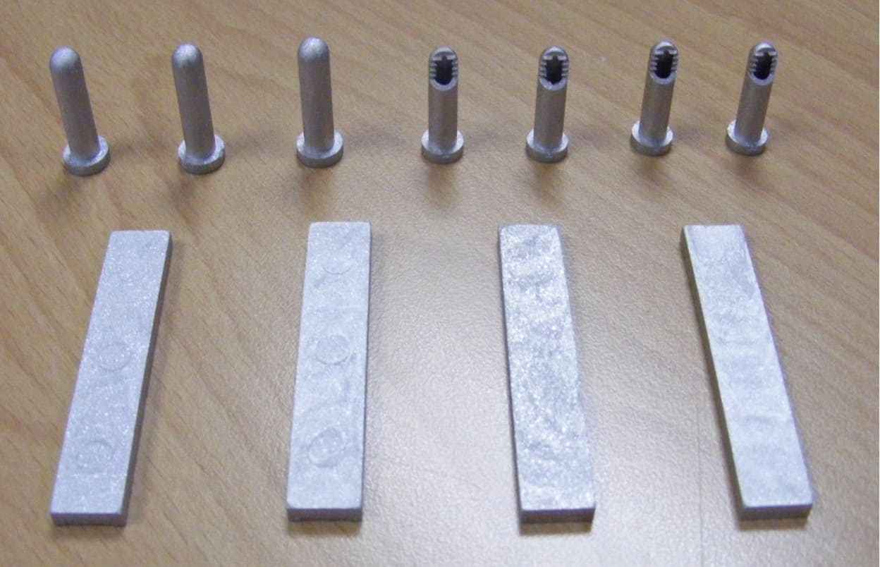 Metallic test specimens on table